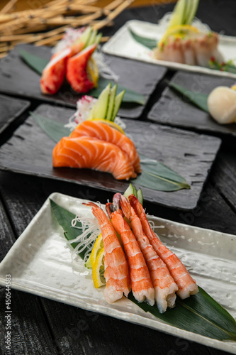 Assorted sashimi on a dark table 