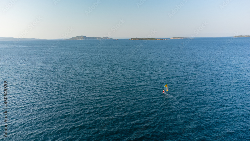 aerial view of Windsurfing, extreme sports. Water sports. Athlete in competition. Seascape with athlete. High quality photo