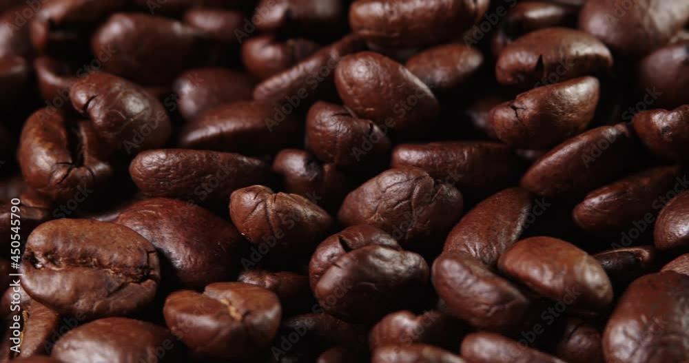 Roasted coffee bean. Fragrant coffee beans scrolls slowly around the camera. Slow Motion Close Up of Whole Roasted Coffee Beans. Roasted coffee bean. Fragrant coffee beans scrolls slowly around the camera. Slow Motion Close Up of Whole Roasted Coffee Beans.