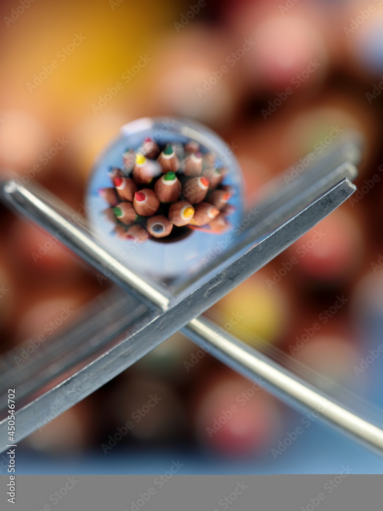 A still life of small transparent balls on forks with a reflection of colored pencils. A still life of small transparent balls on forks with a reflection of colored pencils.