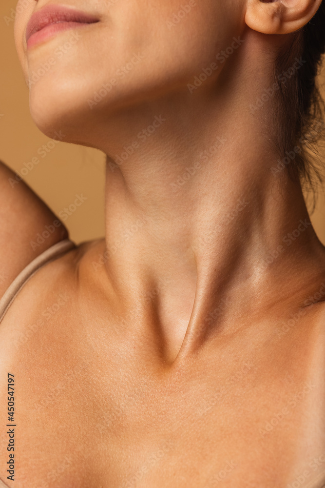 Close up female neck, collarbones isolated on pink studio background. Beautiful caucasian woman with well-kept skin. Close up female neck, collarbones isolated on pink studio background. Beautiful caucasian woman with well-kept skin.
