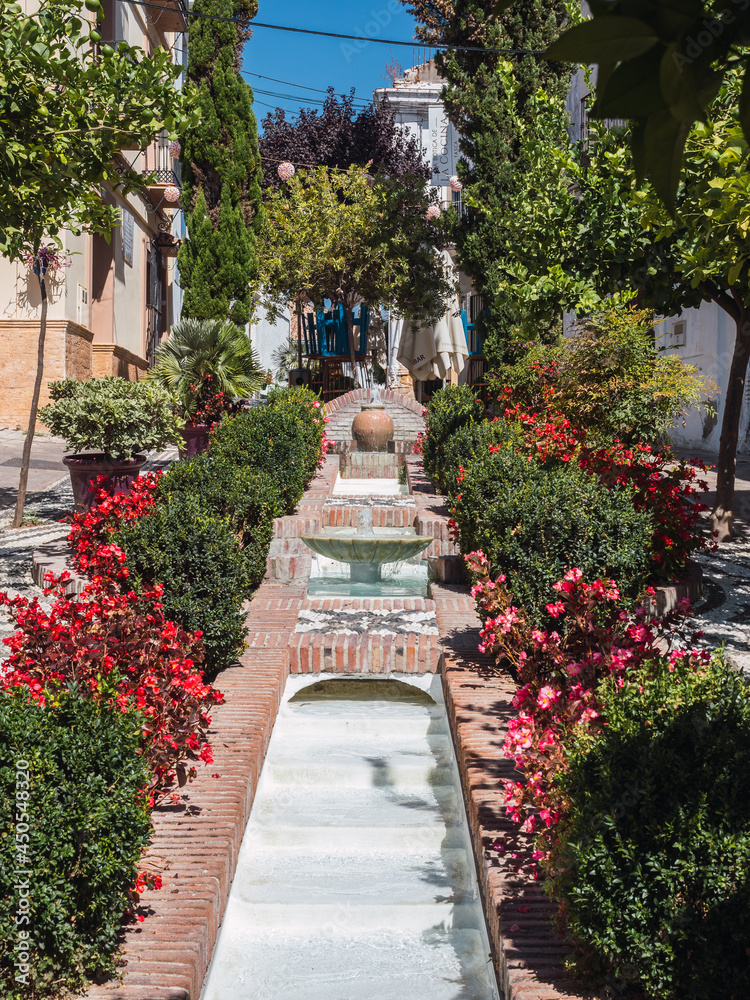 Fountain surrounded by greenery in the old town of Estepona