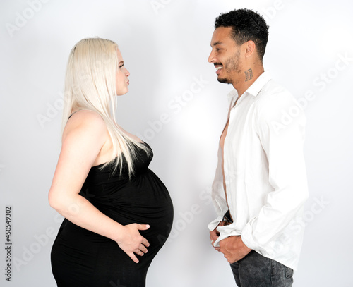 Stylish and happy multi-ethnic couple expecting a baby