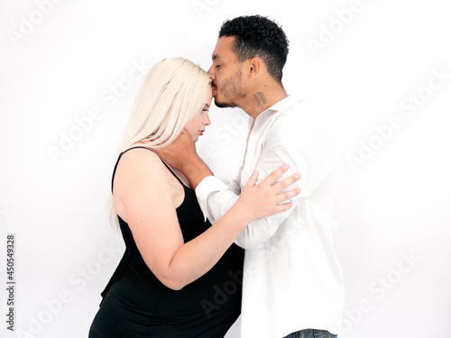 Stylish and happy multi-ethnic couple expecting a baby