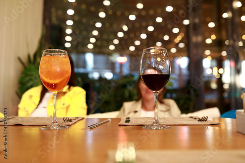 Glasses with aperol and wine on table