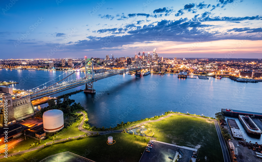 Ben Franklin Bridge and Philadelphia skyline at dusk viewed from above Cooper's Poynt Park, in Camden. Ben Franklin Bridge is a suspension bridge connecting Philadelphia and Camden, NJ.