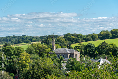 The old Parish Church in Dundonald with its clock tower surrounded by trees and fields. photo