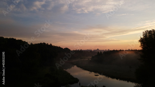 City park, the river flows. Shot at dawn, at sunrise. Aerial photography.