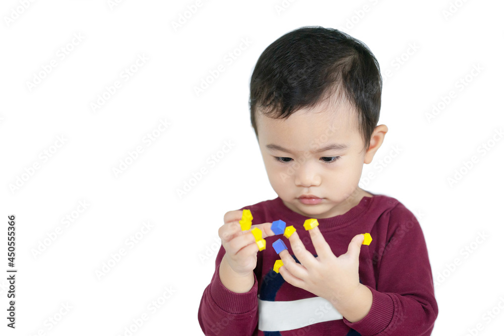 Asian children boy learn through play by putting toys on their fingers with white isolated background, child development concept. Asian children boy learn through play by putting toys on their fingers with white isolated background, child development concept.