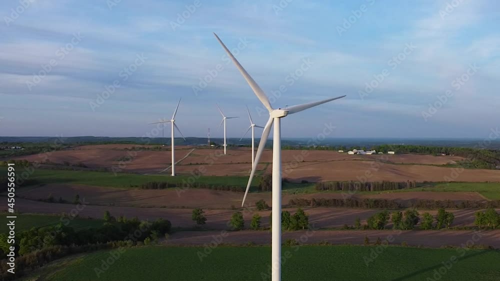 Aerial of renewable sustainable energy wind turbine farms on fields; circle right