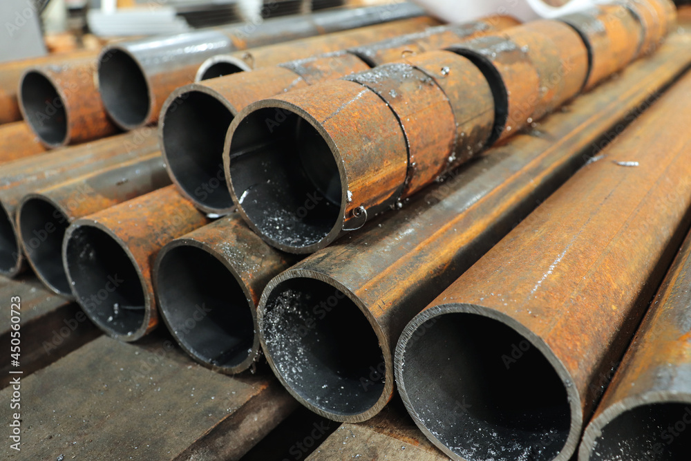 A metal pipe cut into pieces with a band saw. Metal cutting at the factory. A metal pipe cut into pieces with a band saw. Metal cutting at the factory.