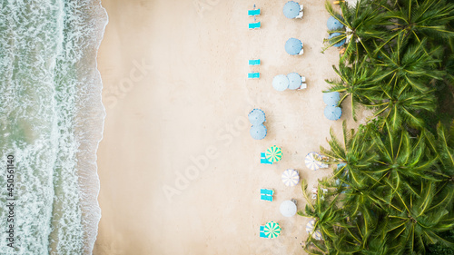 Top view Chairs And Umbrella In Palm Beach.Scenic View Sunset drone shots.