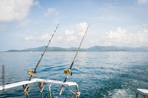 Seascape,Fishing gear reels and rods.Caribbean sea and Ocean beach sunrise and dramatic colorful sky clouds.