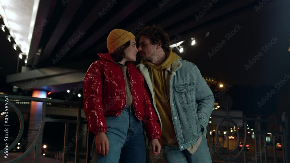 Lovely couple looking eyes to eyes on city background. Pair kissing on street.