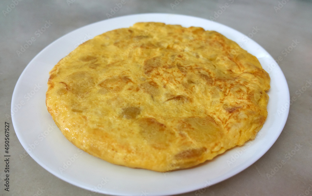 Spanish potato omelette plated on a white plate Spanish potato omelette plated on a white plate