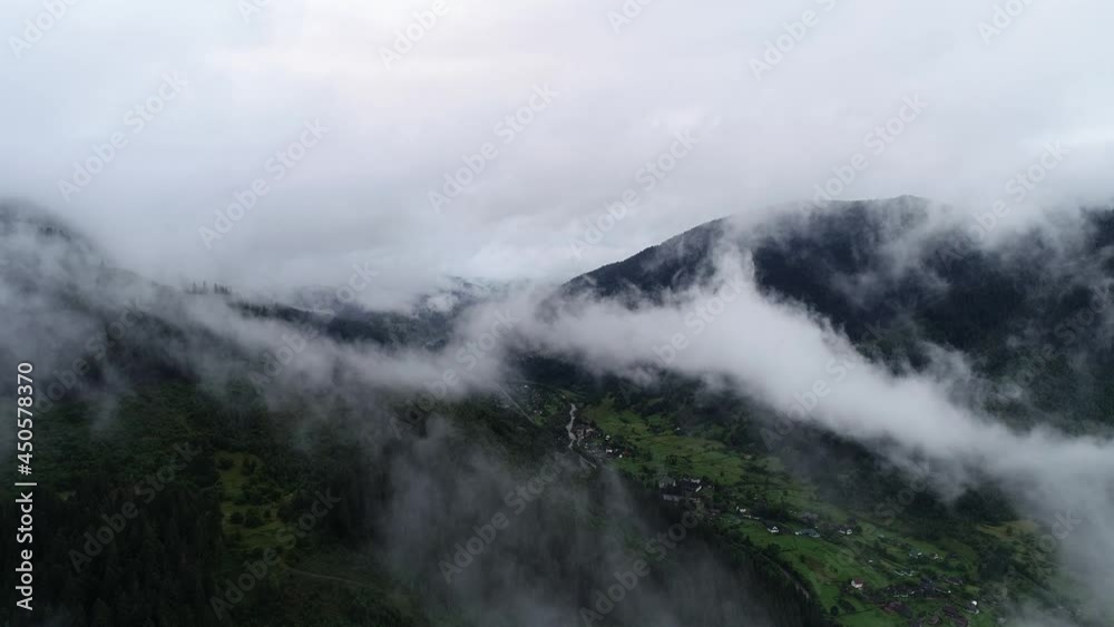 Rainy weather in mountains. Misty fog blowing over pine tree forest. Flying over an amazing rain forest, aerial view above rain forest with fog. Aerial footage of spruce forest trees on the mountain. Rainy weather in mountains. Misty fog blowing over pine tree forest. Flying over an amazing rain forest, aerial view above rain forest with fog. Aerial footage of spruce forest trees on the mountain.