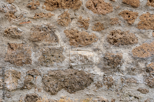 Foto Wall made with many tuff bricks. Wall of tuff stone.