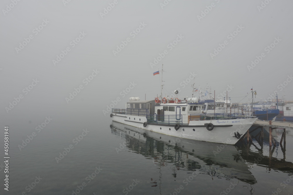 boat in the foggy harbor