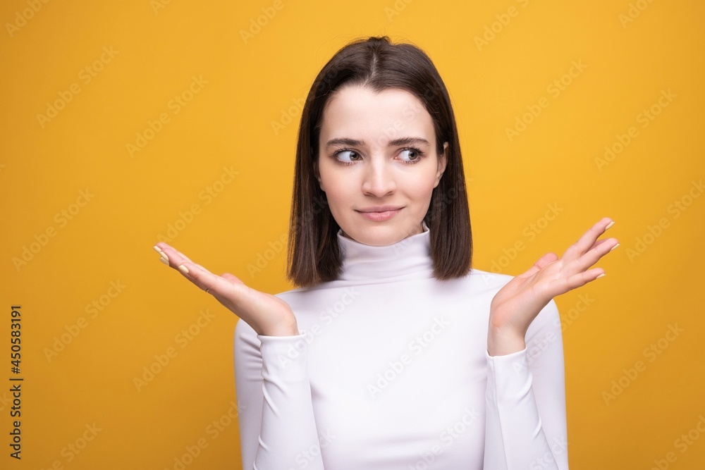 Close-up portrait of a surprised brunette on a yellow background Close-up portrait of a surprised brunette on a yellow background