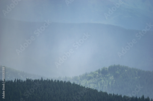 Carpathian mountains and forests in the haze on a summer day