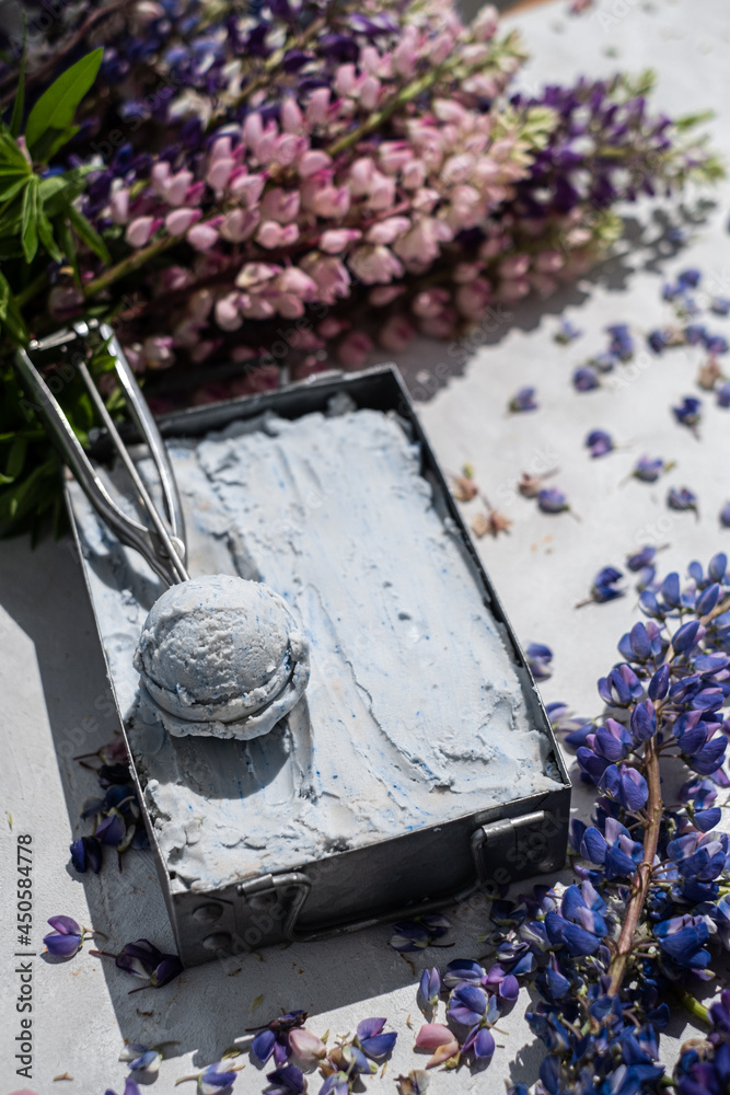 Ice cream in vintage can.  Fresh frozen dessert. Summer joy. Violet syrup, blueberry lavender flavor. Metal tray selective focus. 