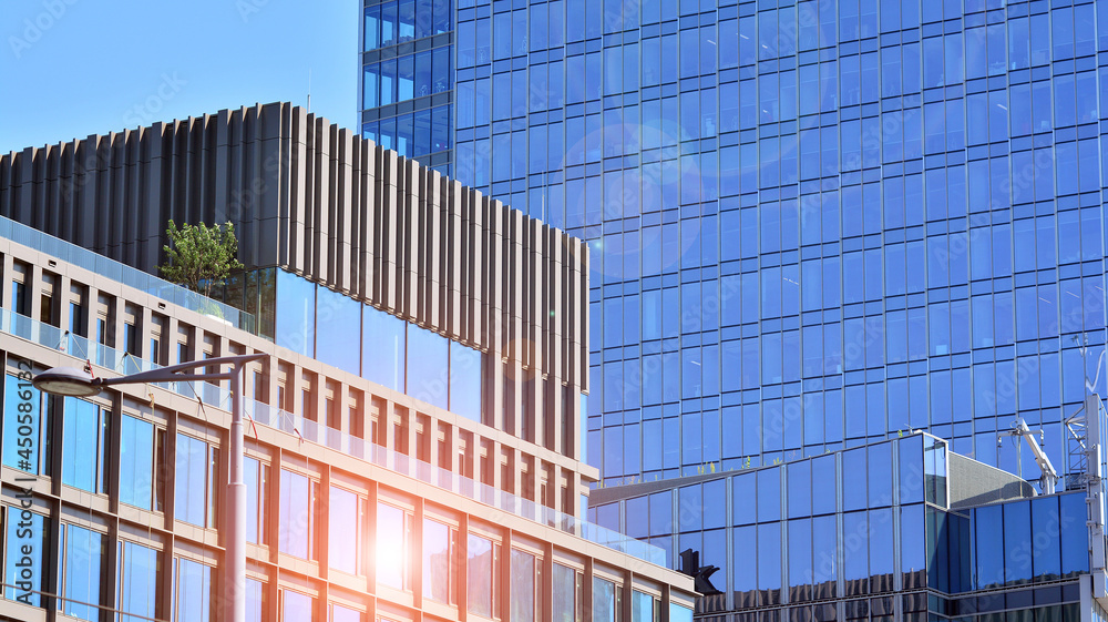 View of office building with glass wall under blue sky. Architecture details of business background. View of office building with glass wall under blue sky. Architecture details of business background.