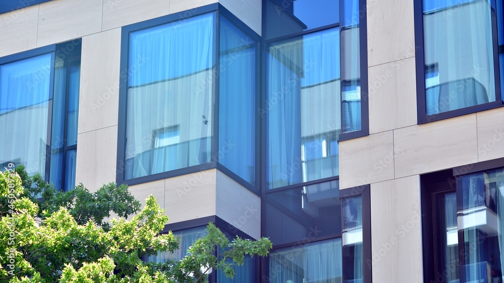 Modern glass office building with green leaves. Eco building and greens plants in city concept. Modern glass office building with green leaves. Eco building and greens plants in city concept.
