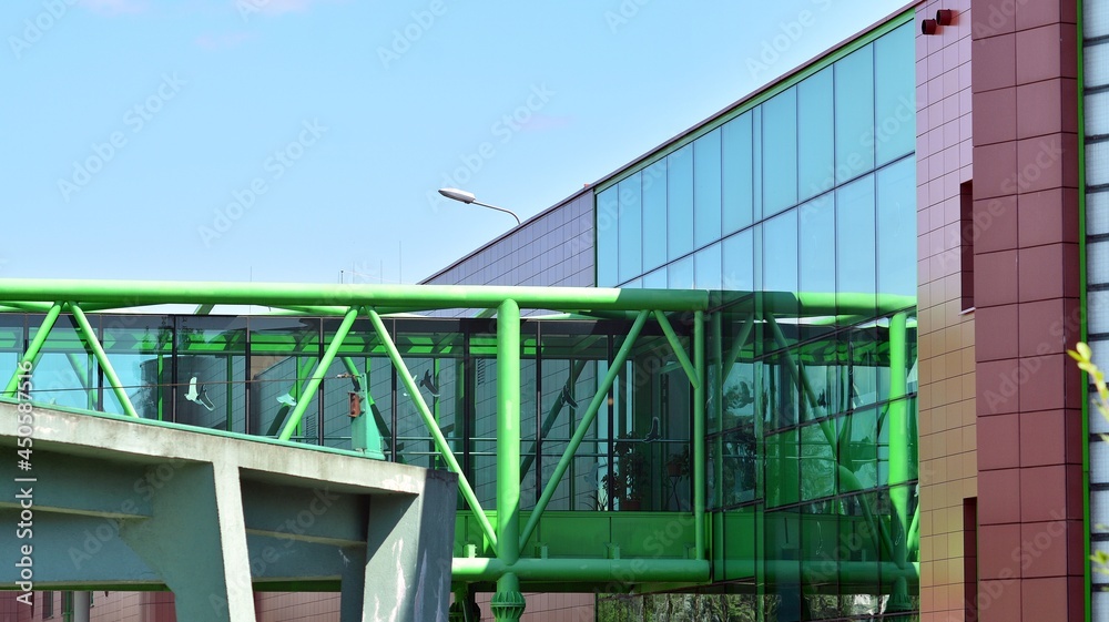 View of office building with glass wall under blue sky. Architecture details of business background. View of office building with glass wall under blue sky. Architecture details of business background.