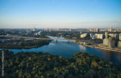 Aerial of cityscape with a river and forest