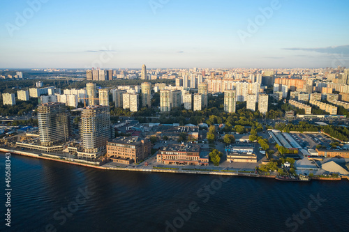 Aerial of construction site on a coastline of the river in big city