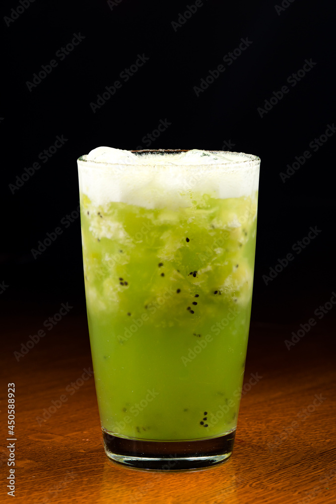 Fresh kiwi cocktail with mint on dark blue background. Summer cold drink and cocktail Fresh kiwi cocktail with mint on dark blue background. Summer cold drink and cocktail