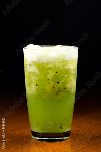 Fresh kiwi cocktail with mint on dark blue background. Summer cold drink and cocktail