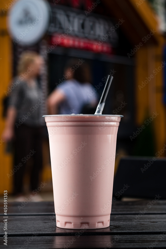 Plastic glass of tasty strawberry milkshake take away Plastic glass of tasty strawberry milkshake take away