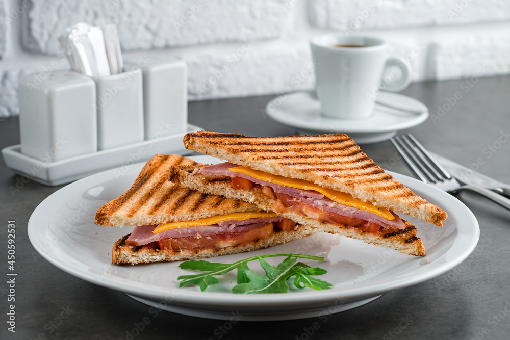 toast with ham, cheese and tomato for breakfast with coffee toast with ham, cheese and tomato for breakfast with coffee