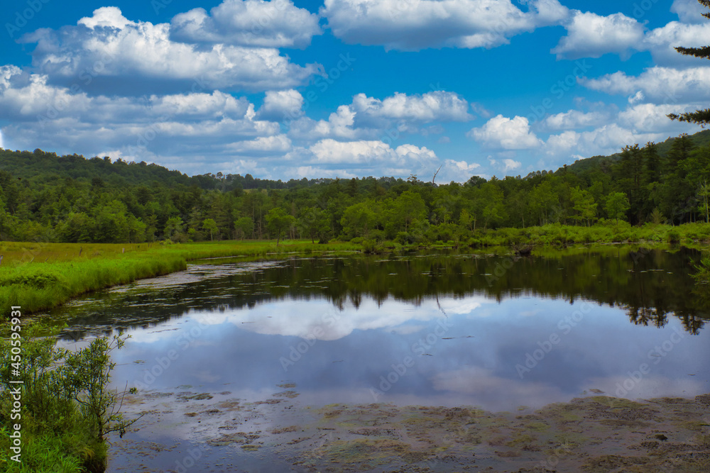 A cloudy sky above Crystal lake in the Catskill mountain region in upstate, New York