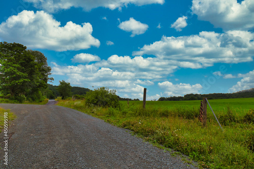 Cloudy skies over a lonely country road somewhere in the Catskills region in upstate  New York