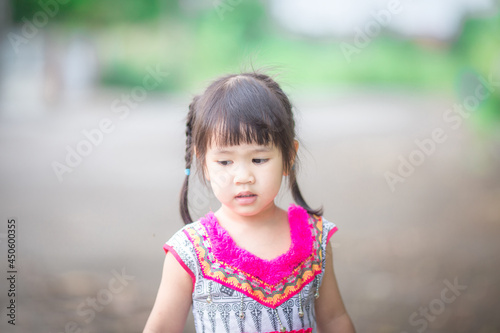 close-up background view of an asian girl Running around and carrying parasols during school holidays, there was a blur of fun movements during the day with parents.