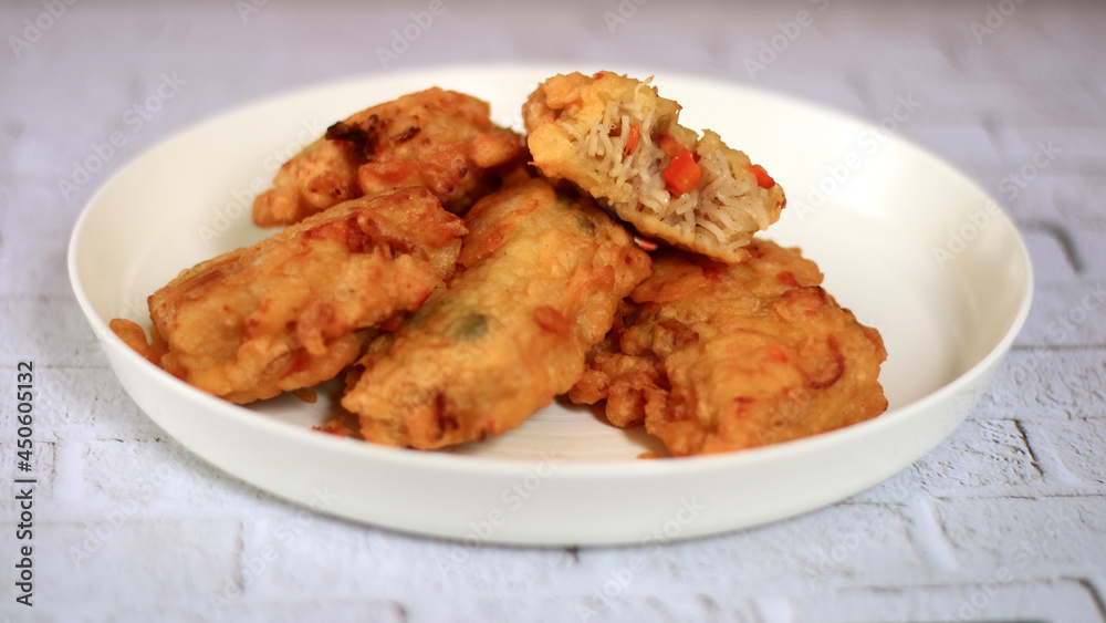 Crispy fried misua cake on white plate. Misua or misoa is thin and soft wheat noodles. Crispy fried misua cake on white plate. Misua or misoa is thin and soft wheat noodles.