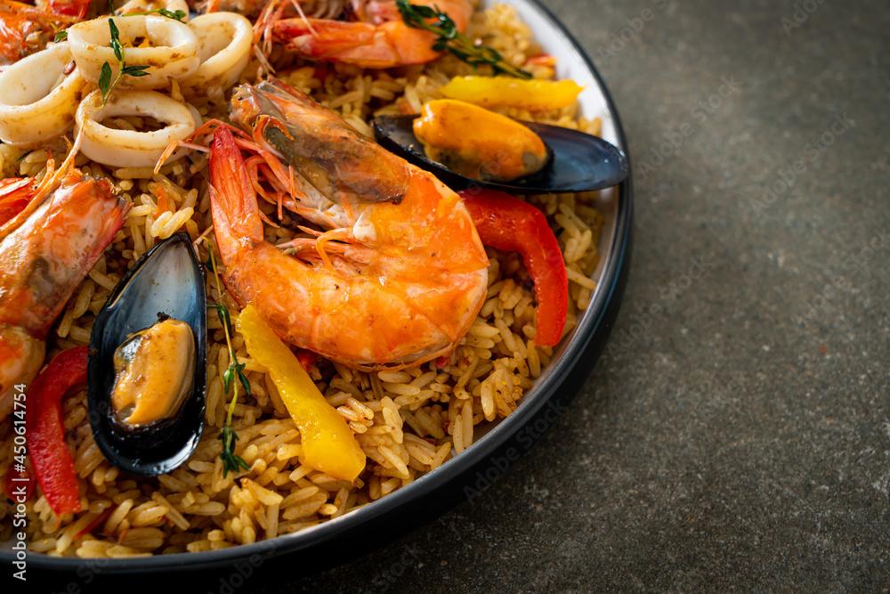 Seafood Paella with prawns, clams, mussels on saffron rice Seafood Paella with prawns, clams, mussels on saffron rice