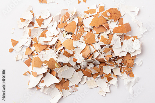 Group of broken eggshells isolated on a white background. Eggshells are brown, brittle and thin, easily broken. Top view.