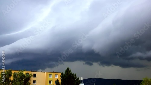 A lightning strike behind a massive shelf cloud over the city Usti nad Labem
