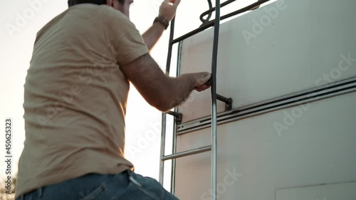 Wallpaper Mural An attractive man climbs the stairs up to the roof of the trailer outside Torontodigital.ca