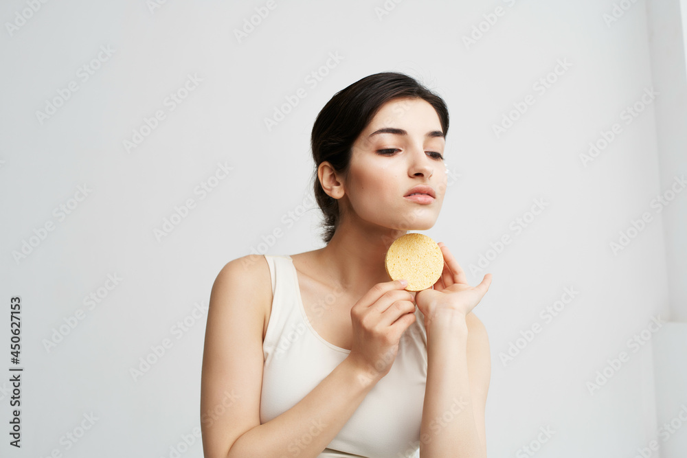 cute brunette in white tank top sponge face clean skin cute brunette in white tank top sponge face clean skin