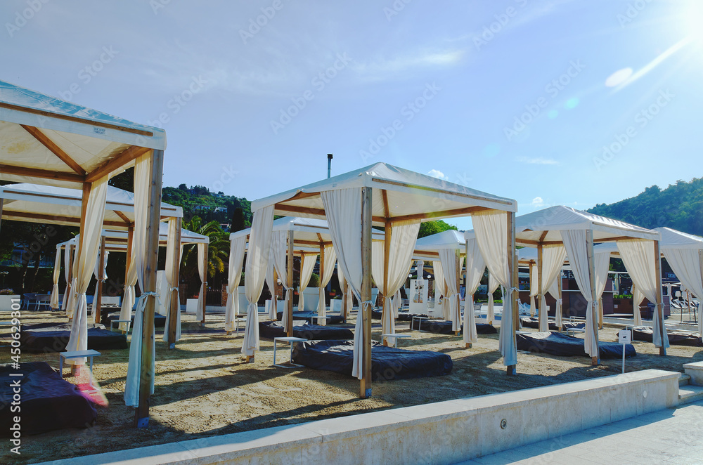 Landscape outdoor cabana bed on the sand beach in sunny day. Adriatic coast and sea in Slovenia. Holiday, wedding and celebration concept. 