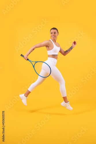 sport game and hobby. summer activity. smiling young girl in sportswear run with racket. © Olena