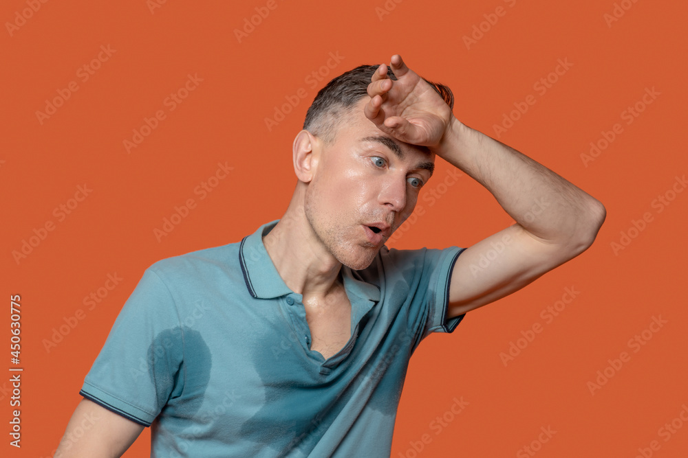 Unhappy man in tshirt with wet spots Unhappy man in tshirt with wet spots
