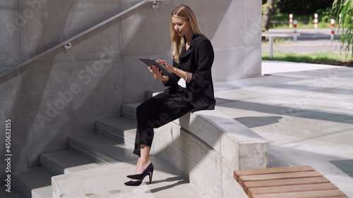 Female manager using tablet on steps