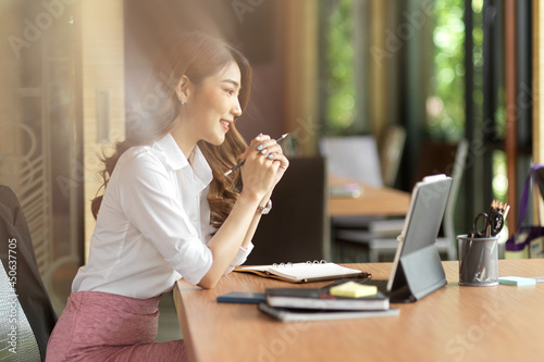 Young female manager feeling happy with her work, online meeting
