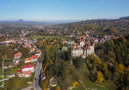 The famous medieval Bran Castle , the residence of count Dracula , situated on a hill in Bran County , Transylvania , Romania , aerial view , autumn season.