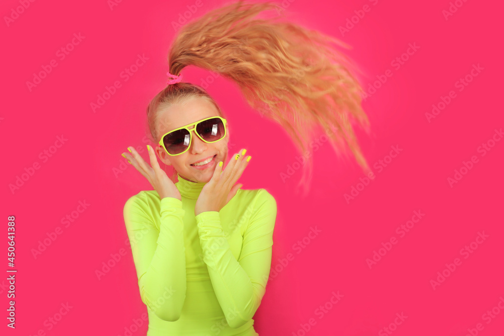 A beautiful cheerful girl in sunglasses on a pink background. A beautiful cheerful girl in sunglasses on a pink background.